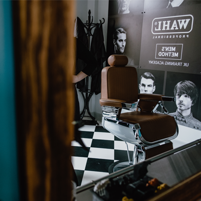 A barber chair sitting in front of a mirror